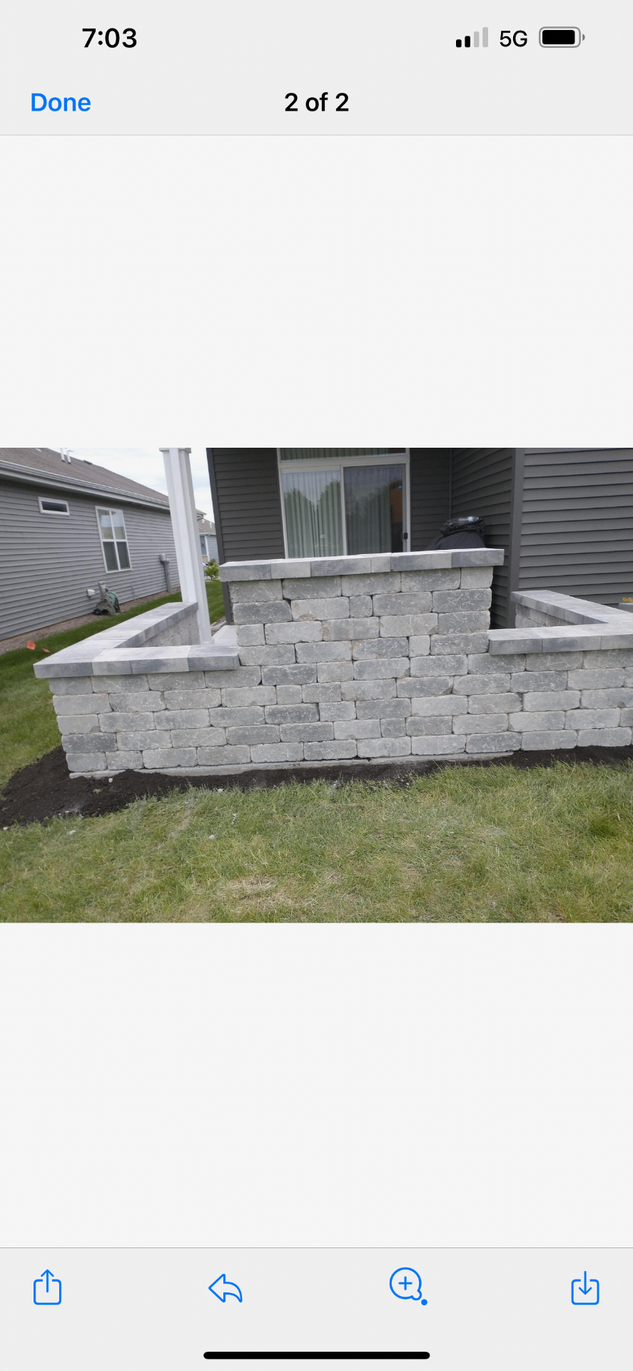 Rear view of a custom backyard stone feature wall under construction