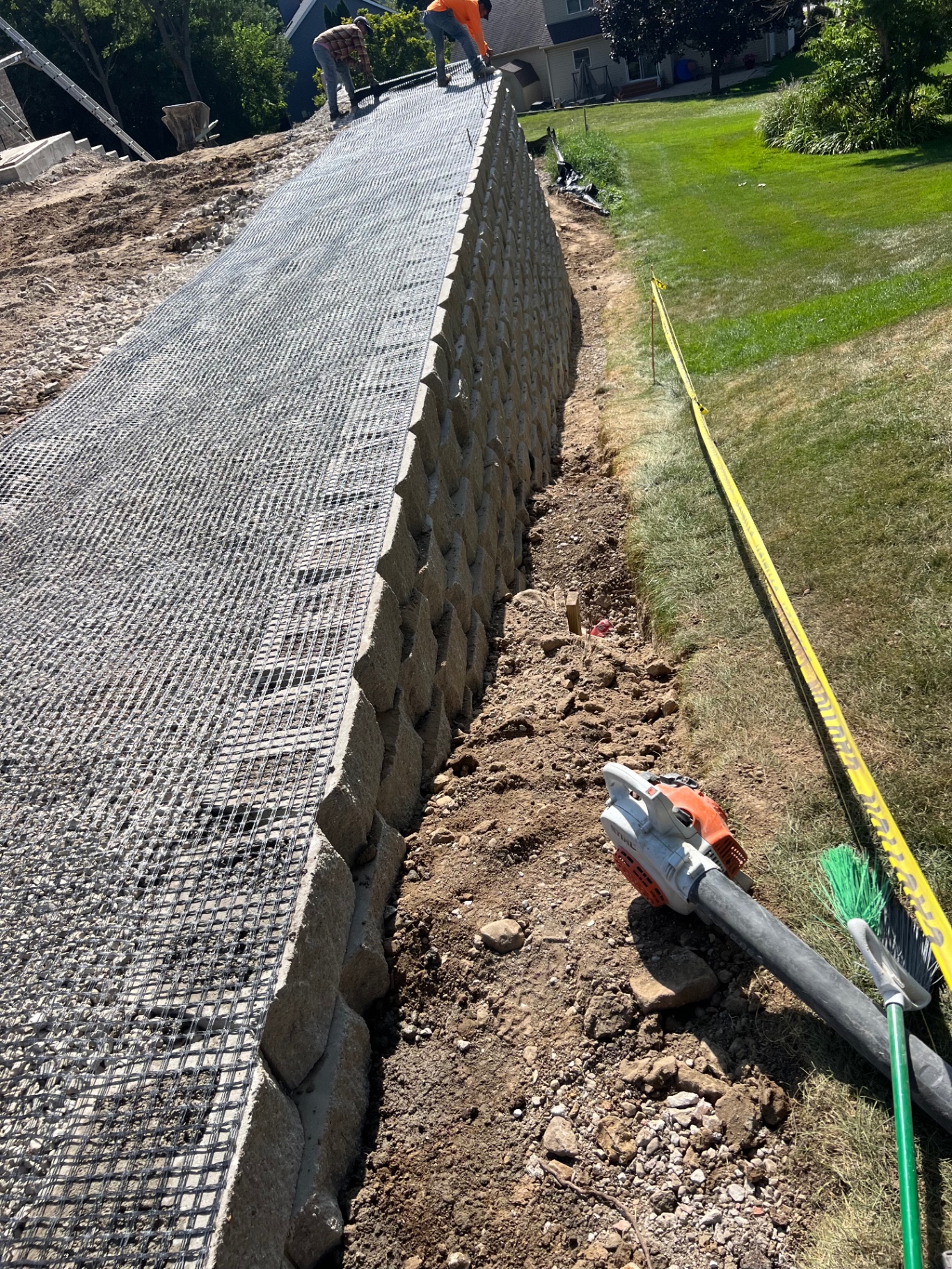 Long retaining wall with geogrid reinforcement layer during construction