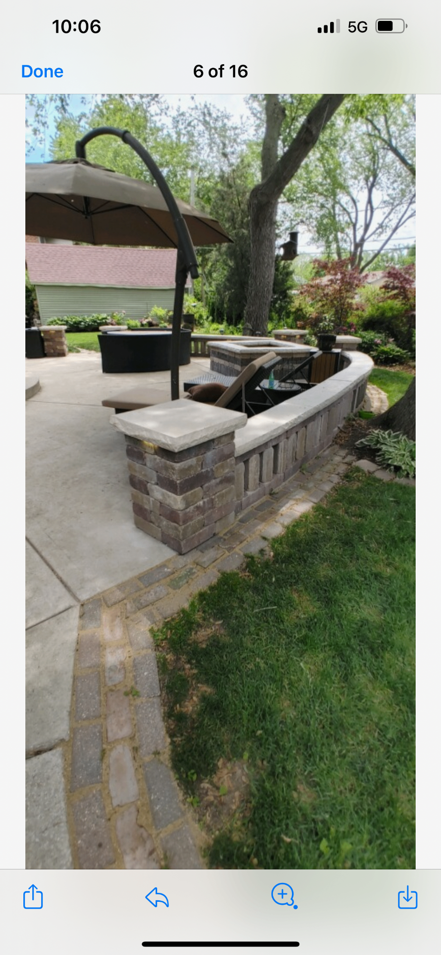 Curved stone seating bench surrounding an outdoor patio area