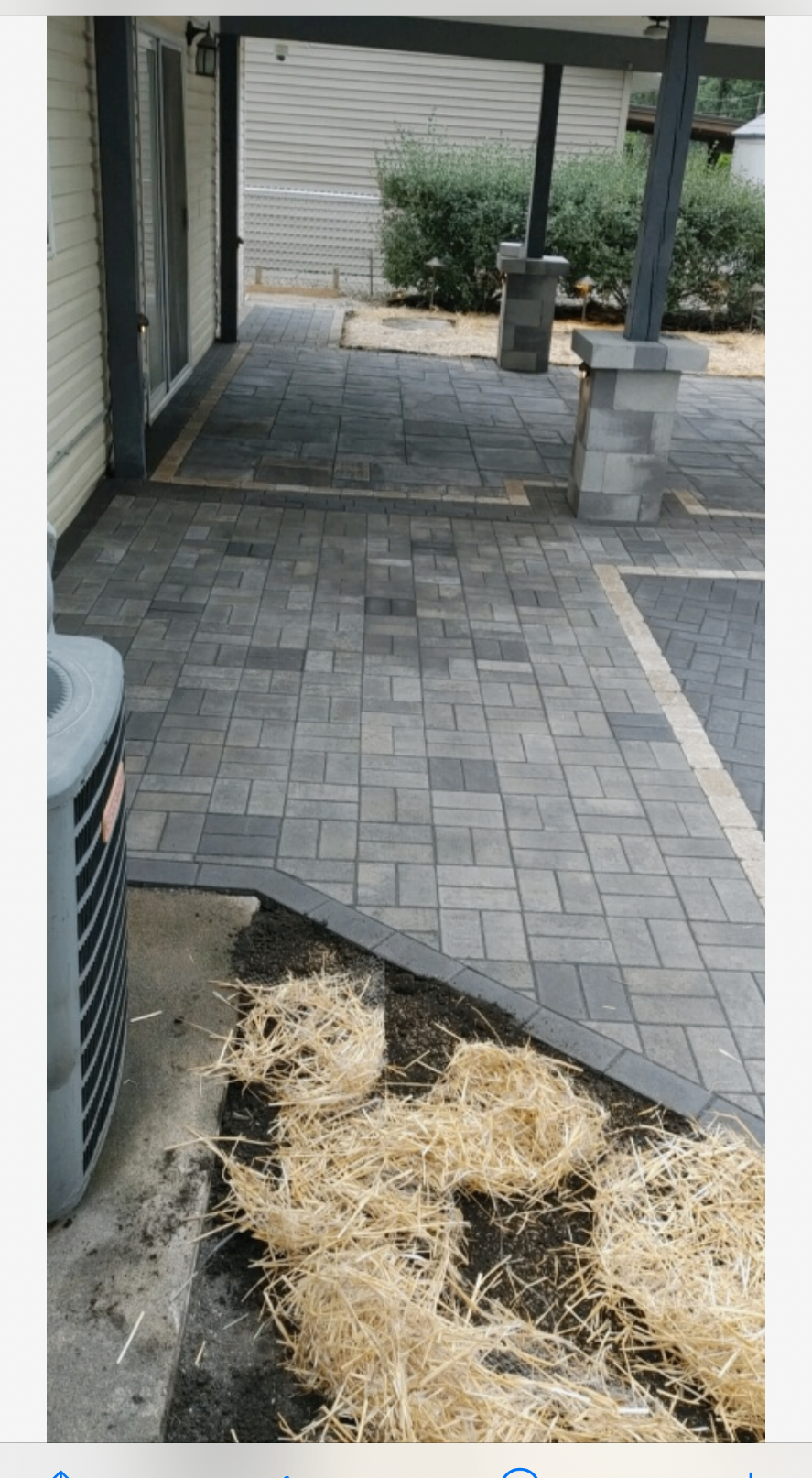 Curved paver walkway with manicured landscaping